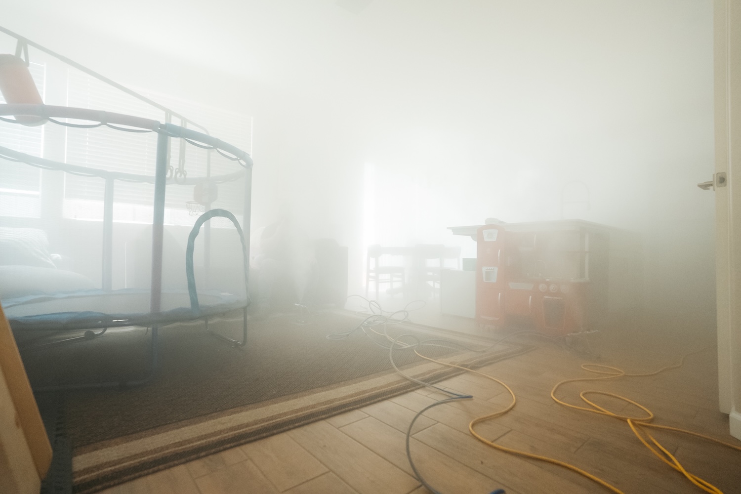 Dry fog filling a Fresno living room during a Pure Maintenance mold treatment