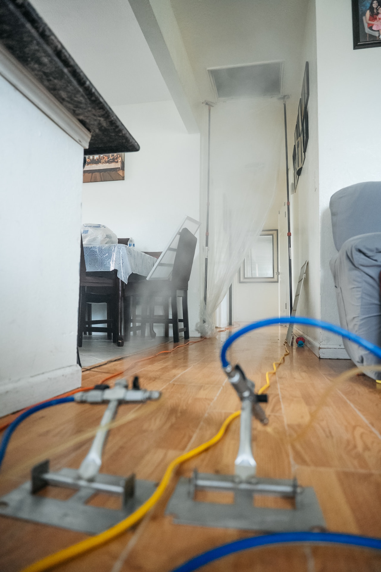 Two dry-fog applicators treating a Clovis home hallway